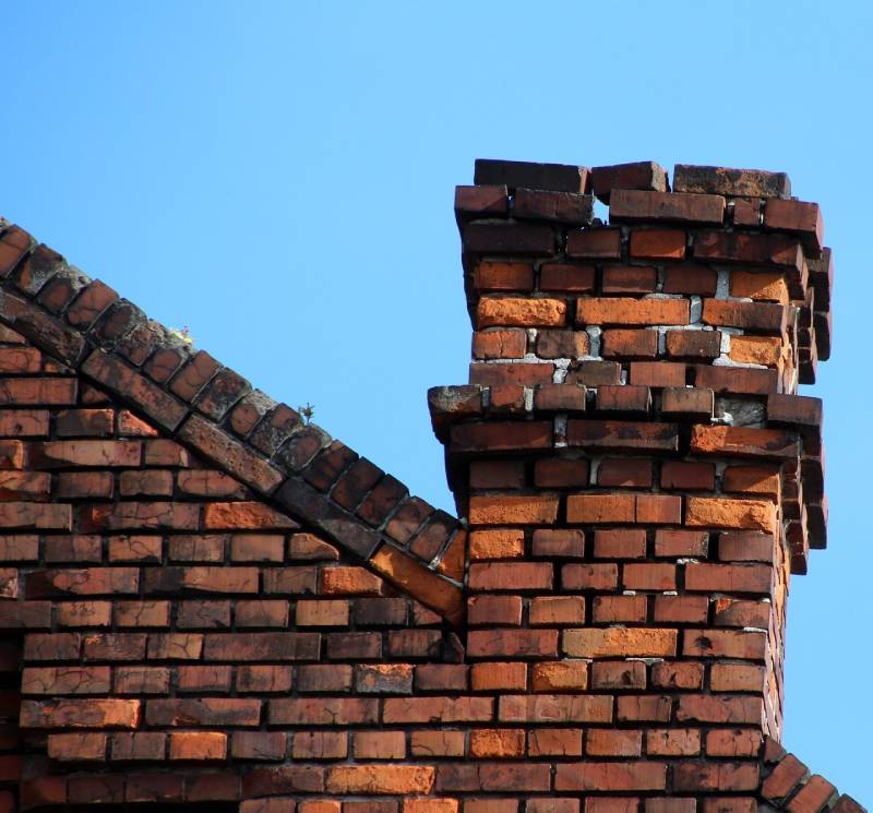Damaged chimney on an Plymouth home showing cracks and missing mortar